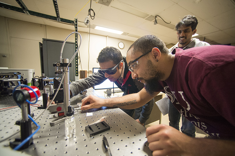 SIU physics students working on a project